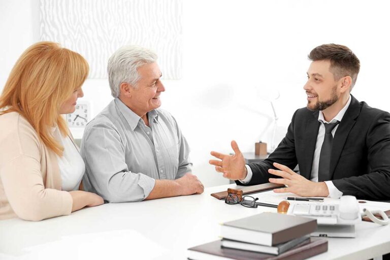 Patient reviewing health insurance documents with a physician before discussing reconstructive surgery.